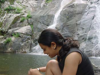 White_Oak_Canyon-Nina_tying_shoe_in_front_of_waterfall